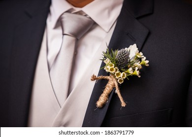 Closeup Of Boutonniere In Twine On Groom's Lapel 