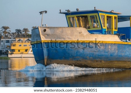 Closeup of bow on industrial river barge boat vessel traveling along large river in Africa 