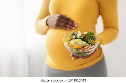 Closeup Of Bowl With Fresh Salad In Pregnant Black Lady Hands, Copy Space. Expecting African American Woman Eating Vegetables During Pregnancy, Nutrition During Carrying Child Concept