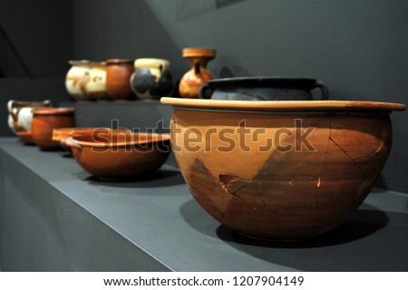 A close-up of bowls / artefacts from ancient Greece exhibited in a museum.