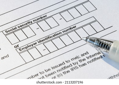 Closeup of the boxes for social security number (SSN) or employer identification number (EIN) on Form W-9, Request for Taxpayer Identification Number (TIN) and Certification. - Shutterstock ID 2113207196