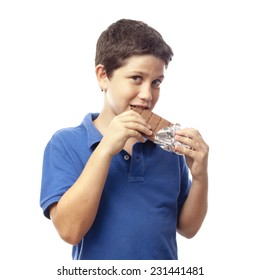 Closeup Of Boy Eating Chocolate Bar