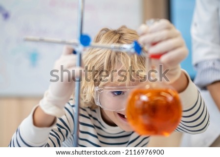 Similar – Image, Stock Photo Happy kid looking liquid through magnifying glass