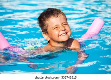 Close-up Of Boy Learning To Swim With Pool Noodle