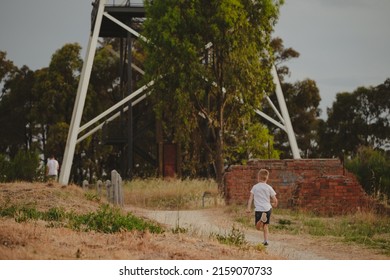 A Closeup Of A Boy Running Outside