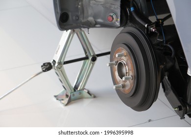 Closeup Brake Pads Of Car With Car Jack Up The Car.