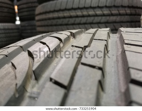 closeup of\
lot of brand new tires at tire warehouse\
