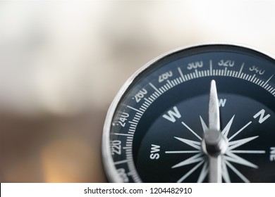 Close-up brass antique compass on marble table - Shutterstock ID 1204482910