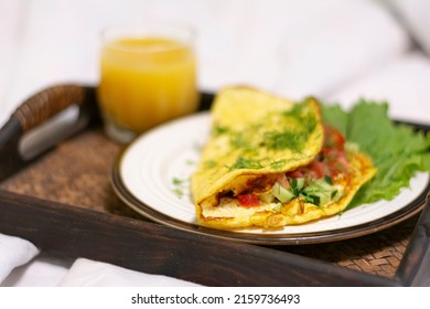 Close-up Of A Breakfast Tray With Scrambled Eggs With Herbs And A Glass Of Orange Juice In A Stylish White Bed No People. Concept: Healthy Breakfast In Bed On A Tray 