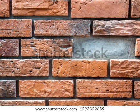 Close-up brick wall background with missing brick. Empty space from missing brick from the wall.