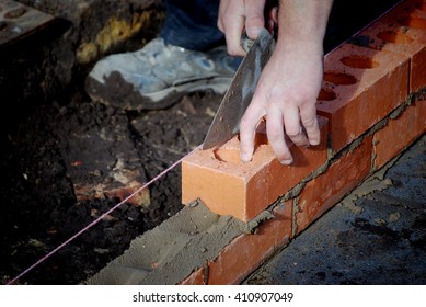 Closeup Of Bricklayer During The Building Of A House Extension.