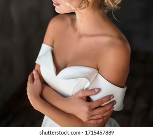 Close-up of the bride folder, hugging. the bride without veil. wedding dress with bare shoulders