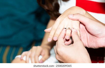 Close-up Bride puts marry ring on Groom's finger or giving her engagement ring. Will you marry me.