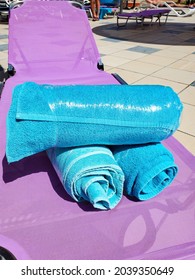 Close-up Of Bright Blue Towels On A Chaise Longue Wrapped In Stretch Film, Security Measures Against Covid During A Hotel Stay, Security From Covid.