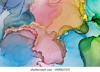 Closeup of bright multicolor and shiny golden alcohol ink abstract texture, trendy wallpaper. Art for design project as background for invitation or greeting cards, flyer, poster, presentation - Shutterstock ID 1909837372