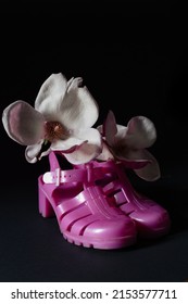 Closeup Of Bright Pink Jellies Shoes With Magnolia Flower Blossom