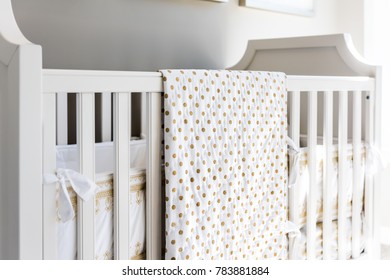 Closeup Of Bright Yellow Baby Crib In Nursery Room In Model Staging Home, Apartment Or House