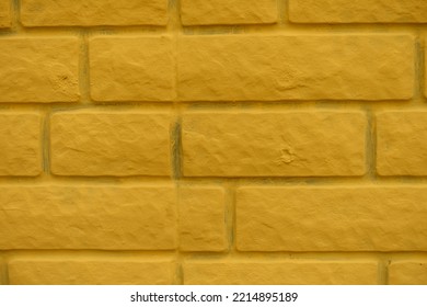 Closeup Of Bright Yellow Painted Brick Veneer Wall