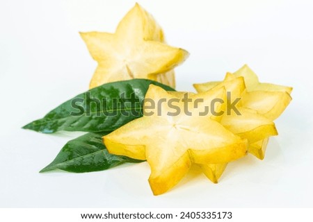 Close-up of a bright yellow star fruit. Cut into pieces and place them on top of each other. It is naturally delicious and nutritious. on a white background