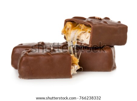 Closeup of broken chocolate bar (nougat topped with caramel, enrobed in milk chocolate) isolated on white background