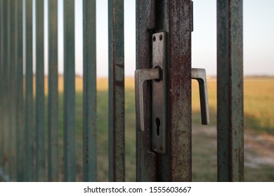 Close-up Of Broken Door Handle On A Steel Property Fencing Entrance Gate With Missing Lock