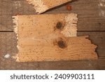 Close-up of a broken floorboard with holes, infested with wood-eating larvae. A plank infested with woodworm. Top view.