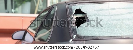 Closeup of broken rear glass of black car