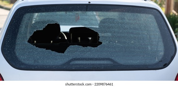 Closeup Of Broken Rear Windshield Glass On The Back Of A Car With No People