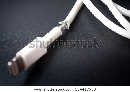 Closeup the Broken Smart Phone Charger Cable on black Background.