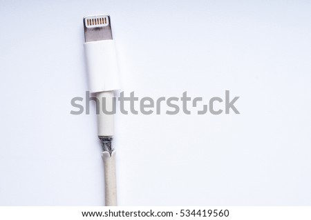 Closeup the Broken Smart Phone Charger Cable on white Background.
