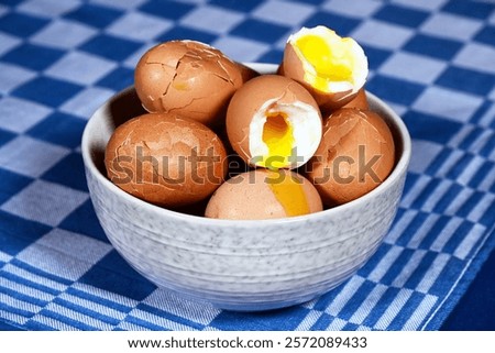Close-up of Broken soft-boiled chicken eggs in a bowl in a kitchen