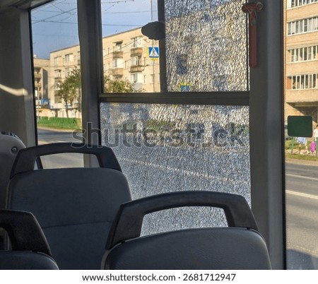 close-up of broken windows on a bus