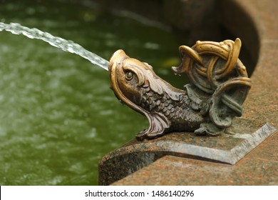 Closeup of a bronze fish statue, traditional fountain decoration