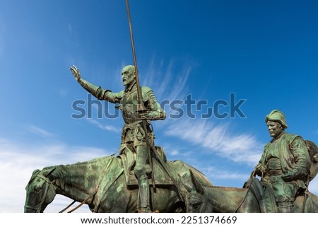 Closeup of the bronze statues of Don Quixote de la Mancha and Sancho Panza, part of the monument to Miguel de Cervantes, 1929, in Plaza de Espana (Spain square), Madrid downtown, Spain, Europe. 
