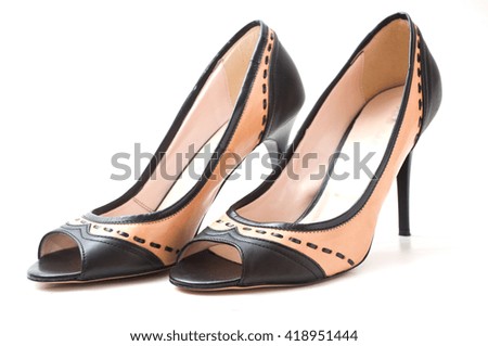 closeup of  brown and black  stilettos shoes on white background 
