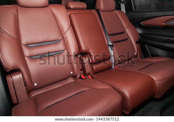 Close-up of the brown  leather rear seats with\
seats belt. modern car\
interior\
