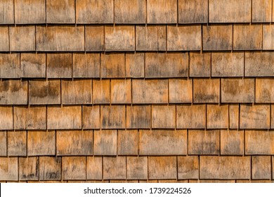 Closeup of brown rustic shake and shingle siding on an old house in Annapolis Maryland cedar sidewall shingles fit with traditional aesthetic
