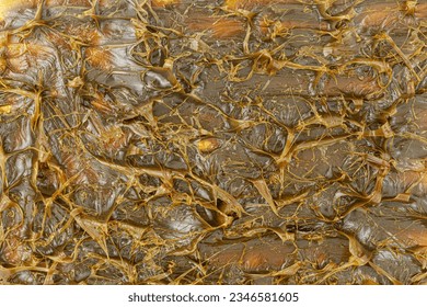 Close-Up of Brown-colored textured MPLR lubricating molybdenum disulfide grease for machinery lubrication. Top view