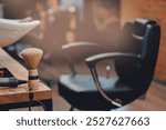 Closeup brush for shaving beard in barbershop. Blurred background of hair salon for men, barber shop.