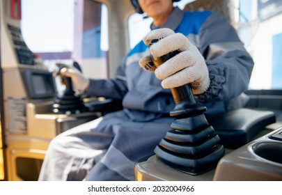 Close-up of builder hands operate crane or excavator at construction site. - Shutterstock ID 2032004966