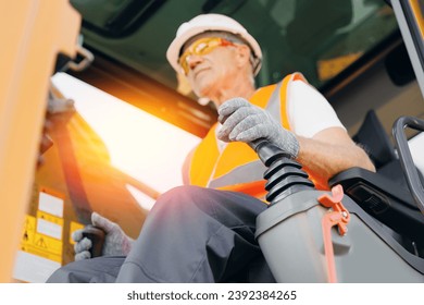 Close-up of builder hands operate crane or excavator at construction site
