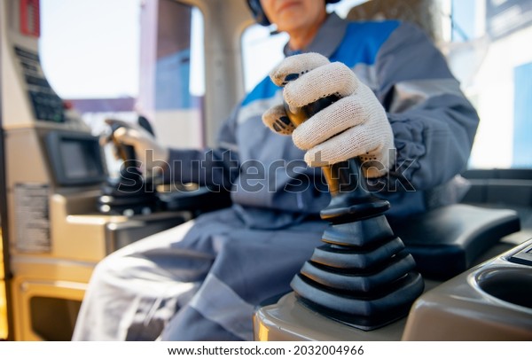 Close-up of builder hands operate crane or\
excavator at construction\
site.