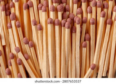 A close-up of a bundle of matches on grey background