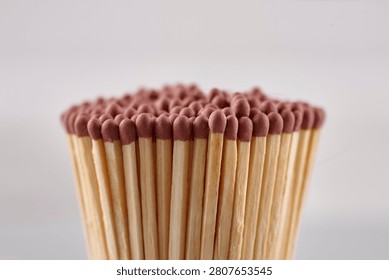 A close-up of a bundle of matches on grey background