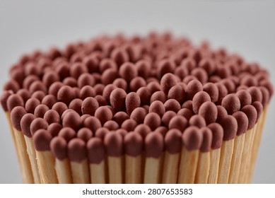 A close-up of a bundle of matches on grey background
