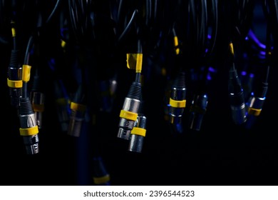 Close-up of bundles of XLR cables for connecting concert equipment.