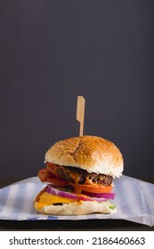 Close-up Of Burger Against Gray Background With Copy Space. Unaltered, Food, Snack, Fast Food, Studio Shot And Unhealthy Food Concept,