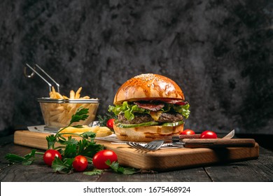 Closeup burger, fries and tomatoes - Powered by Shutterstock