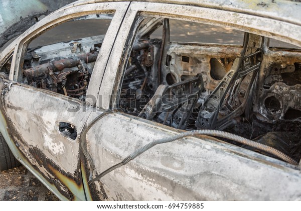 Close-up of Burned Out\
Car on the Street