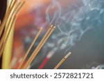 close-up of burning incense stick with bokeh background during Chinese Lunar New Year celebration. Aromatherapy, incense for prayer and meditation. prayer to Buddha. incense for relaxation and yoga